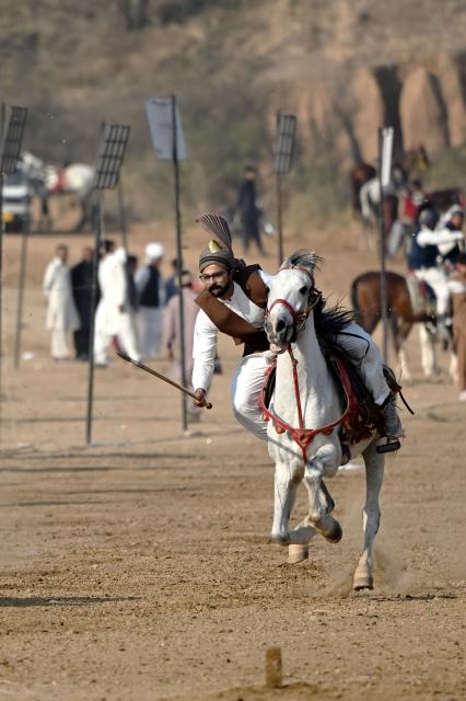 (260111) -- ISLAMABAD, Jan. 11, 2026 (Xinhua) -- A rider competes during a tent pegging competition in Islamabad, Pakistan, Jan. 11, 2026. In tent pegging, a horseman gallops and uses a sword or a lance to pierce, pick up and carry away a wooden peg. (Xinhua/Ahmad Kamal)