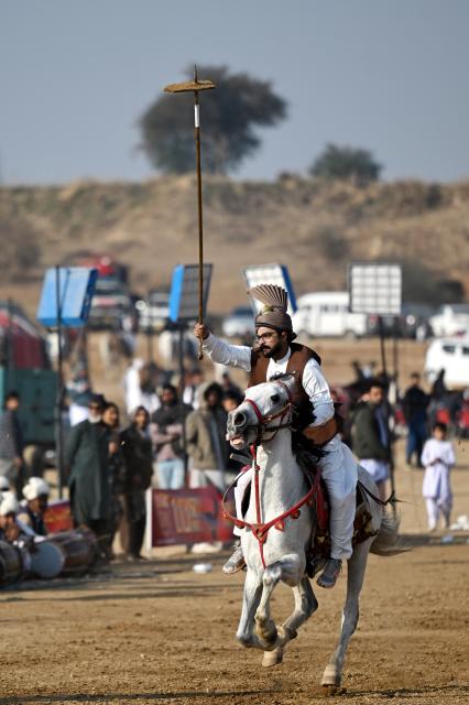 (260111) -- ISLAMABAD, Jan. 11, 2026 (Xinhua) -- A rider competes during a tent pegging competition in Islamabad, Pakistan, Jan. 11, 2026. In tent pegging, a horseman gallops and uses a sword or a lance to pierce, pick up and carry away a wooden peg. (Xinhua/Ahmad Kamal)