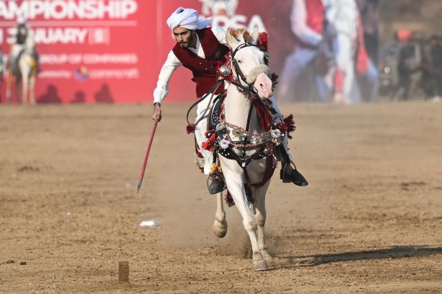 (260111) -- ISLAMABAD, Jan. 11, 2026 (Xinhua) -- A rider competes during a tent pegging competition in Islamabad, Pakistan, Jan. 11, 2026. In tent pegging, a horseman gallops and uses a sword or a lance to pierce, pick up and carry away a wooden peg. (Xinhua/Ahmad Kamal)
