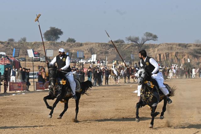 (260111) -- ISLAMABAD, Jan. 11, 2026 (Xinhua) -- Riders compete during a tent pegging competition in Islamabad, Pakistan, Jan. 11, 2026. In tent pegging, a horseman gallops and uses a sword or a lance to pierce, pick up and carry away a wooden peg. (Xinhua/Ahmad Kamal)