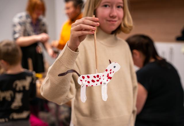 (260112) -- BEIJING, Jan. 12, 2026 (Xinhua) -- A girl shows the puppet she made at the Museum of Prague in Prague, the Czech Republic, Jan. 10, 2026. The Museum of Prague held a family-oriented event on Jan. 10, featuring a puppet show about a garbage collector's daily work and hands-on puppet-making activities to promote sustainable practices. (Photo by Dana Kesnerova/Xinhua)