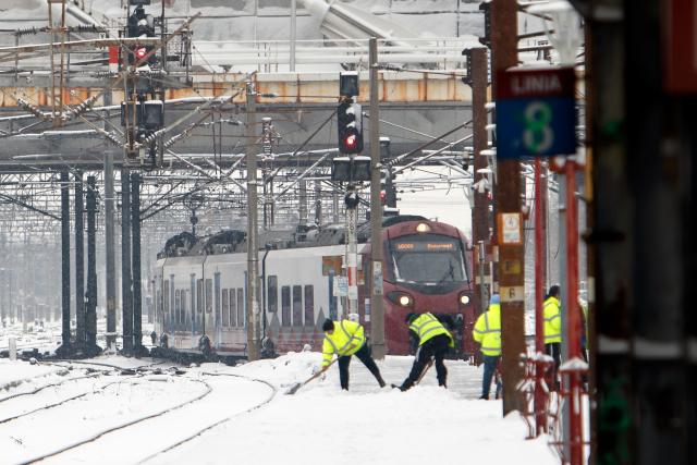 (260112) -- BUCHAREST, Jan. 12, 2026 (Xinhua) -- Workers clear snow amid snowfall at North Railway station in Bucharest, Romania, on Jan. 11, 2026.
  Romania is facing a severe winter episode, with snowfall, blizzards, persistent frost and extremely low temperatures in large parts of the country. (Photo by Cristian Cristel/Xinhua)