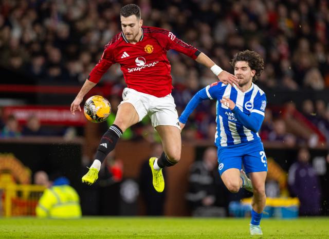 (260112) -- MANCHESTER, Jan. 12, 2026 (Xinhua) -- Manchester United's Diogo Dalot (L) controls the ball during the FA Cup 3rd Round match between Manchester United FC and Brighton & Hove Albion FC in Manchester, Britain, on Jan. 11, 2026. FOR EDITORIAL USE ONLY. NOT FOR SALE FOR MARKETING OR ADVERTISING CAMPAIGNS. NO USE WITH UNAUTHORIZED AUDIO, VIDEO, DATA, FIXTURE LISTS, CLUB/LEAGUE LOGOS OR "LIVE" SERVICES. ONLINE IN-MATCH USE LIMITED TO 45 IMAGES, NO VIDEO EMULATION. NO USE IN BETTING, GAMES OR SINGLE CLUB/LEAGUE/PLAYER PUBLICATIONS. (Xinhua)