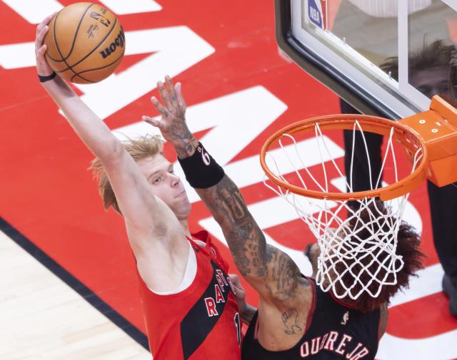 (260112) -- TORONTO, Jan. 12, 2026 (Xinhua) -- Gradey Dick (L) of Toronto Raptors dunks during the 2025-2026 NBA regular season game between Toronto Raptors and Philadelphia 76ers in Toronto, Canada, on Jan. 11, 2026. (Photo by Zou Zheng/Xinhua)