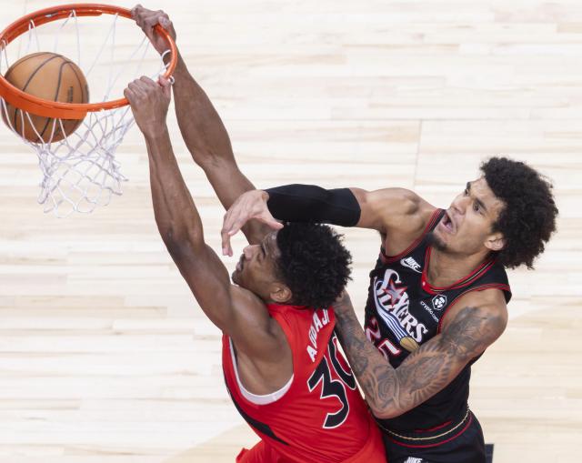 (260112) -- TORONTO, Jan. 12, 2026 (Xinhua) -- Ochai Agbaji (L) of Toronto Raptors dunks during the 2025-2026 NBA regular season game between Toronto Raptors and Philadelphia 76ers in Toronto, Canada, on Jan. 11, 2026. (Photo by Zou Zheng/Xinhua)