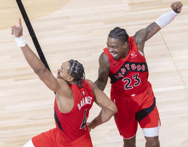 (260112) -- TORONTO, Jan. 12, 2026 (Xinhua) -- Scottie Barnes (L) and Jamal Shead of Toronto Raptors celebrate victory after the 2025-2026 NBA regular season game between Toronto Raptors and Philadelphia 76ers in Toronto, Canada, on Jan. 11, 2026. (Photo by Zou Zheng/Xinhua)