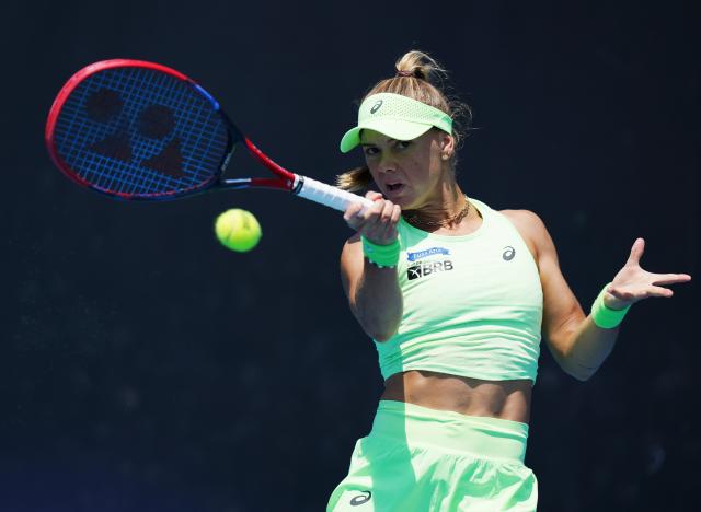 (260112) -- MELBOURNE, Jan. 12, 2026 (Xinhua) -- Laura Pigossi of Brazil hits a return during the women's singles qualifying 1st round match against Zhu Lin of China at Australian Open tennis tournament in Melbourne, Australia, Jan. 12, 2026. (Xinhua/Wang Shen)