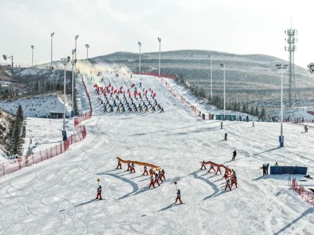 (260112) -- HOHHOT, Jan. 12, 2026 (Xinhua) -- An aerial drone photo taken on Dec. 14, 2025 shows a scene during the opening ceremony of a national ice and snow season in Hohhot, north China's Inner Mongolia Autonomous Region. Hohhot has launched more than 300 winter amusement programs since December 2025, incorporating ice and snow sports, cultural experiences and vogue consumption to boost the local economy. (Xinhua/Li Zhipeng)