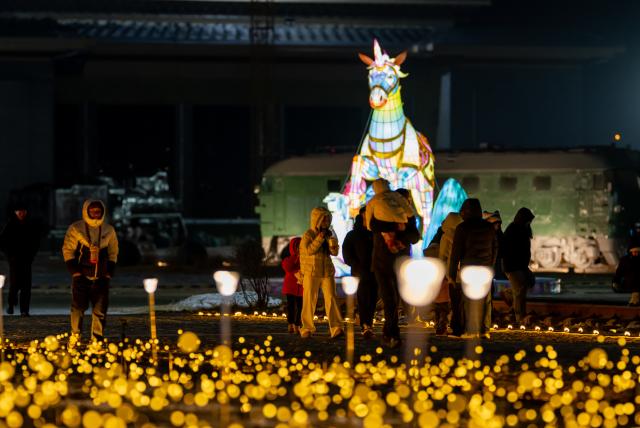 (260112) -- HOHHOT, Jan. 12, 2026 (Xinhua) -- This photo taken on Dec. 31, 2025 shows people attending an ice and snow festival in Hohhot, north China's Inner Mongolia Autonomous Region. Hohhot has launched more than 300 winter amusement programs since December 2025, incorporating ice and snow sports, cultural experiences and vogue consumption to boost the local economy. (Xinhua/Lian Zhen)