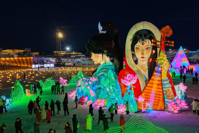 (260112) -- HOHHOT, Jan. 12, 2026 (Xinhua) -- A drone photo taken on Dec. 31, 2025 shows people attending an ice and snow festival in Hohhot, north China's Inner Mongolia Autonomous Region. Hohhot has launched more than 300 winter amusement programs since December 2025, incorporating ice and snow sports, cultural experiences and vogue consumption to boost the local economy. (Photo by Xu Ting/Xinhua)