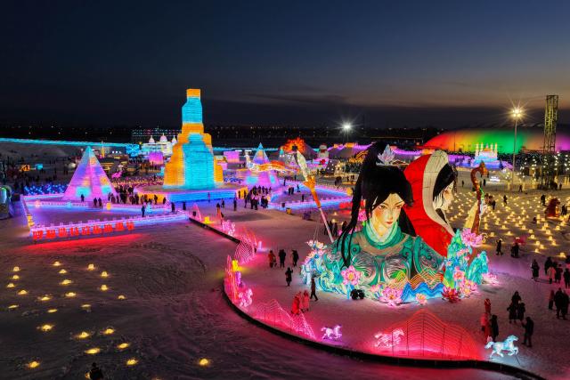 (260112) -- HOHHOT, Jan. 12, 2026 (Xinhua) -- A drone photo taken on Dec. 31, 2025 shows people attending an ice and snow festival in Hohhot, north China's Inner Mongolia Autonomous Region. Hohhot has launched more than 300 winter amusement programs since December 2025, incorporating ice and snow sports, cultural experiences and vogue consumption to boost the local economy. (Photo by Xu Ting/Xinhua)