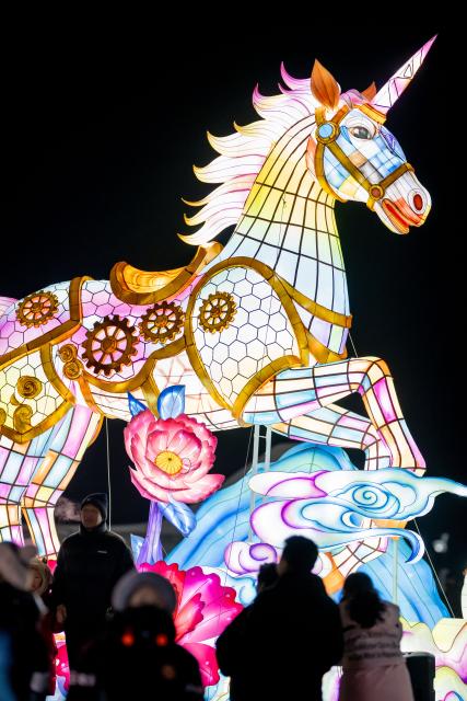 (260112) -- HOHHOT, Jan. 12, 2026 (Xinhua) -- A drone photo taken on Dec. 31, 2025 shows people attending an ice and snow festival in Hohhot, north China's Inner Mongolia Autonomous Region. Hohhot has launched more than 300 winter amusement programs since December 2025, incorporating ice and snow sports, cultural experiences and vogue consumption to boost the local economy. (Xinhua/Lian Zhen)