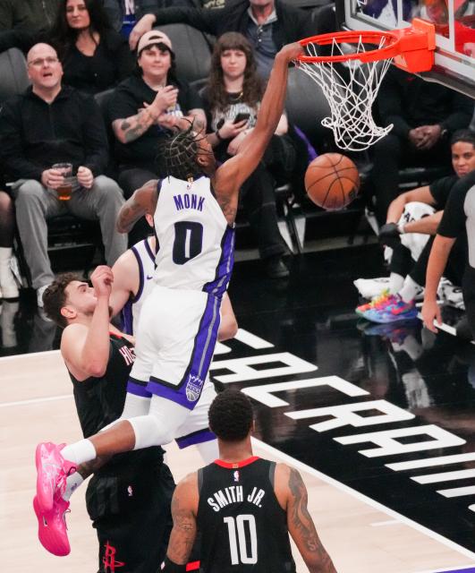 (260112) -- SACRAMENTO, Jan. 12, 2026 (Xinhua) -- Malik Monk (top) of Sacramento Kings dunks during the 2025-2026 NBA regular season match between Sacramento Kings and Houston Rockets in Sacramento, the United States, on Jan. 11, 2026. (Photo by Sun Yuxuan/Xinhua)