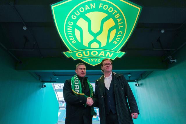 (260112) -- BEIJING, Jan. 12, 2026 (Xinhua) -- Matthias Brosamer (R), new sports general manager of Beijing Guoan Football Club, and Nick Montgomery, new head coach of Beijing Guoan, the Chinese Super League (CSL) club, shake hands at the Worker's Stadium in Beijing, capital of China, Jan. 12, 2026. (Xinhua/Ju Huanzong)
