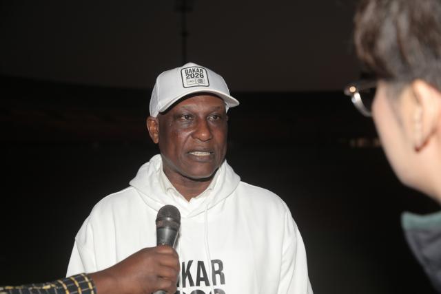 (260112) -- DAKAR, Jan. 12, 2026 (Xinhua) -- Ibrahima Wade, general coordinator of the Organizing Committee of the Dakar 2026 Youth Olympic Games (YOG), speaks during an interview with a Xinhua reporter at the Leopold Sedar Senghor Stadium in Dakar, Senegal, Jan. 11, 2026. TO GO WITH "Interview: Dakar 2026 Youth Olympic Games to boost China-Africa sports exchanges" (Photo by Aliou Mbaye/Xinhua)