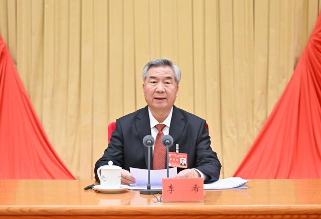 (260112) -- BEIJING, Jan. 12, 2026 (Xinhua) -- Li Xi, a member of the Standing Committee of the Political Bureau of the Communist Party of China (CPC) Central Committee and secretary of the CPC Central Commission for Discipline Inspection (CCDI), delivers a work report on behalf of the standing committee of the CCDI during the fifth plenary session of the 20th CPC CCDI in Beijing, capital of China, Jan. 12, 2026. The fifth plenary session of the 20th CPC CCDI opened here on Monday. (Xinhua/Yue Yuewei)