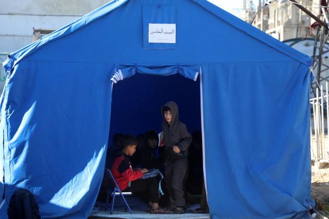 (260112) -- GAZA, Jan. 12, 2026 (Xinhua) -- Students attend a class at Al-Shamal Educational School, located just 100 meters from the "Yellow Line" in Jabalia Refugee Camp, northern Gaza Strip, Jan. 12, 2026. (Photo by Rizek Abdeljawad/Xinhua)