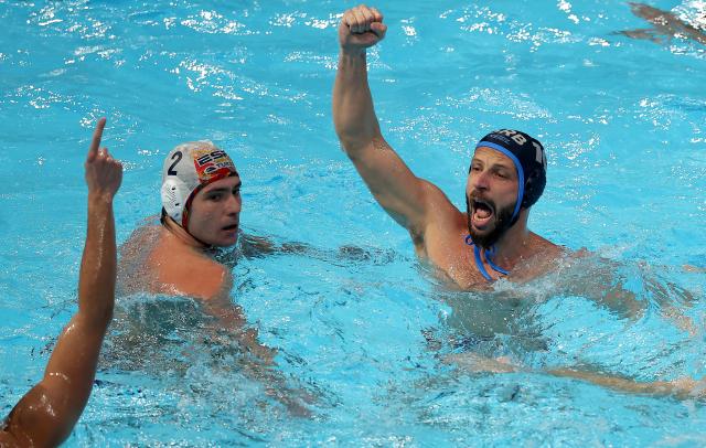 (260113) -- BELGRADE, Jan. 13, 2026 (Xinhua) -- Serbia's Nikola Dedovic (R) celebrates his goal past Spain's Alberto Munarriz during the group C match between Spain and Serbia at the Men's European Water Polo Championships in Belgrade, Serbia, Jan. 12, 2026. (Photo by Predrag Milosavljevic/Xinhua)
