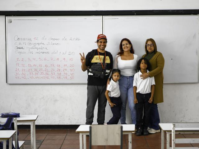 (260113) -- CARACAS, Jan. 13, 2026 (Xinhua) -- Several teachers and students pose for a group photo in a classroom on the first day of  the new semester in a public school in Caracas, Venezuela, Jan. 12, 2026. The second half of the 2025-2026 academic year for primary and secondary education began on Monday in Venezuela. (Xinhua/Ding Hongfa)