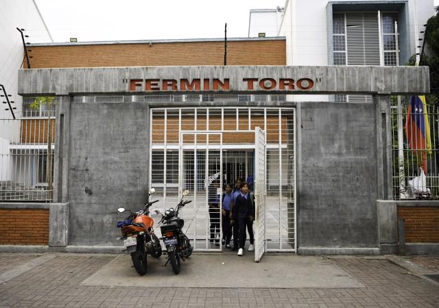 (260113) -- CARACAS, Jan. 13, 2026 (Xinhua) -- Students come out from a public school after finishing class on the first day of the new semester in Caracas, Venezuela, Jan. 12, 2026. The second half of the 2025-2026 academic year for primary and secondary education began on Monday in Venezuela. (Xinhua/Ding Hongfa)