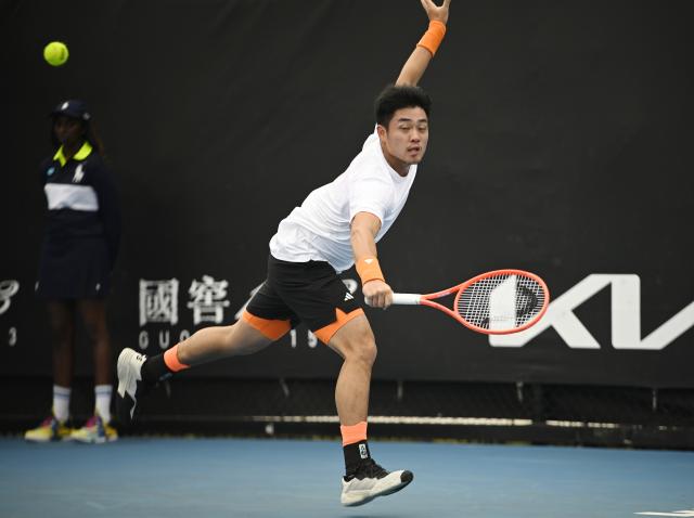 (260113) -- MELBOURNE, Jan. 13, 2026 (Xinhua) -- Wu Yibing of China hits a return during the men's singles qualifying 1st round match against Mitchell Krueger of the United States at Australian Open tennis tournament in Melbourne, Australia, Jan. 13, 2026. (Photo by Wang Shen/Xinhua)
