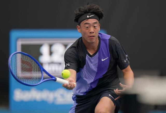 (260113) -- MELBOURNE, Jan. 13, 2026 (Xinhua) -- Coleman Wong of China's Hong Kong hits a return during the men's singles qualifying 1st round match against Ugo Blanchet of France at Australian Open tennis tournament in Melbourne, Australia, Jan. 13, 2026. (Photo by Wang Shen/Xinhua)
