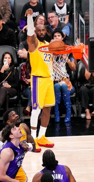 (260113) -- SACRAMENTO, Jan. 13, 2026 (Xinhua) -- Los Angeles Lakers' LeBron James (back) makes a three-point field goal during the 2025-2026 NBA regular season game between Sacramento Kings and Los Angeles Lakers in Sacramento, the United States, on Jan. 12, 2026. (Photo by Sun Yuxuan/Xinhua)