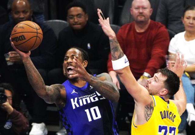 (260113) -- SACRAMENTO, Jan. 13, 2026 (Xinhua) -- Sacramento Kings' DeMar DeRozan (L) goes for a layup during the 2025-2026 NBA regular season game between Sacramento Kings and Los Angeles Lakers in Sacramento, the United States, on Jan. 12, 2026. (Xinhua/Wu Xiaoling)