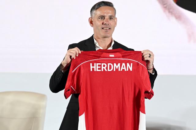 (260113) -- JAKARTA, Jan. 13, 2026 (Xinhua) -- John Herdman holds the Indonesian jersey after press conference in Jakarta, Indonesia, Jan. 13, 2025. The Indonesian Football Association (PSSI) officially announced and introduced John Herdman, the British coach as the new head coach of the Indonesian national football team to the public through a press conference. (Xinhua/Agung Kuncahya B.)