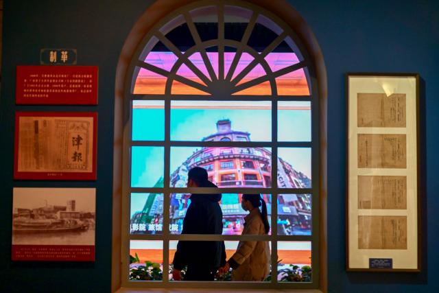 (260113) -- TIANJIN, Jan. 13, 2026 (Xinhua) -- People visit an exhibition featuring modern Tianjin's industry and commerce at the Tianjin Museum in Tianjin, north China, Jan. 13, 2026. Featuring over 320 historical photographs and more than 120 pieces (sets) of physical exhibits, the exhibition will last for three months and be open to the public free of charge. (Xinhua/Sun Fanyue)