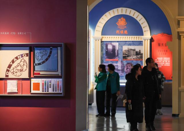 (260113) -- TIANJIN, Jan. 13, 2026 (Xinhua) -- People visit an exhibition featuring modern Tianjin's industry and commerce at the Tianjin Museum in Tianjin, north China, Jan. 13, 2026. Featuring over 320 historical photographs and more than 120 pieces (sets) of physical exhibits, the exhibition will last for three months and be open to the public free of charge. (Xinhua/Sun Fanyue)