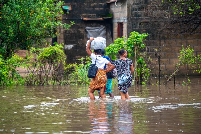 (260113) -- MATOLA, Jan. 13, 2026 (Xinhua) -- Residents wade through floodwater caused by heavy rainfall in Matola City, Maputo Province, Mozambique, Jan. 12, 2026. Mozambique is currently in the peak of its rainy season, a period marked by frequent alerts for heavy rains and strong winds, particularly in the central and southern regions. (Photo by Mendes Mondlane/Xinhua)