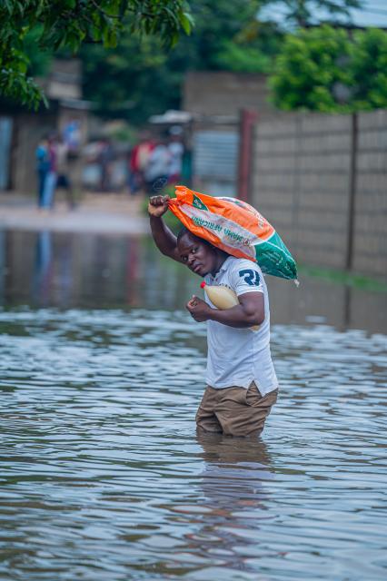 (260113) -- MATOLA, Jan. 13, 2026 (Xinhua) -- A resident wades through floodwater caused by heavy rainfall in Matola City, Maputo Province, Mozambique, Jan. 12, 2026. Mozambique is currently in the peak of its rainy season, a period marked by frequent alerts for heavy rains and strong winds, particularly in the central and southern regions. (Photo by Mendes Mondlane/Xinhua)