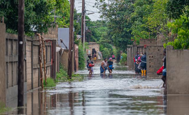 (260113) -- MATOLA, Jan. 13, 2026 (Xinhua) -- Residents wade through floodwater caused by heavy rainfall in Matola City, Maputo Province, Mozambique, Jan. 12, 2026. Mozambique is currently in the peak of its rainy season, a period marked by frequent alerts for heavy rains and strong winds, particularly in the central and southern regions. (Photo by Mendes Mondlane/Xinhua)