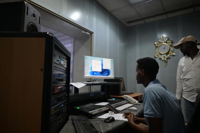(260113) -- MOGADISHU, Jan. 13, 2026 (Xinhua) -- Staff members work at the recording room of Radio Mogadishu in Mogadishu, Somalia, on Jan. 12, 2026. Radio Mogadishu, established in 1951, is one of the official state-run broadcasting organizations in Somalia. The archives of Radio Mogadishu houses a large number of historical audio files, including music, poetry, interviews, political speeches and other contents, which record the social and cultural process of Somalia in recent decades. (Xinhua/Yang Guang)