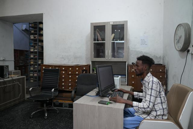(260113) -- MOGADISHU, Jan. 13, 2026 (Xinhua) -- A staff member works at the archives of Radio Mogadishu in Mogadishu, Somalia, on Jan. 12, 2026. Radio Mogadishu, established in 1951, is one of the official state-run broadcasting organizations in Somalia. The archives of Radio Mogadishu houses a large number of historical audio files, including music, poetry, interviews, political speeches and other contents, which record the social and cultural process of Somalia in recent decades. (Xinhua/Yang Guang)