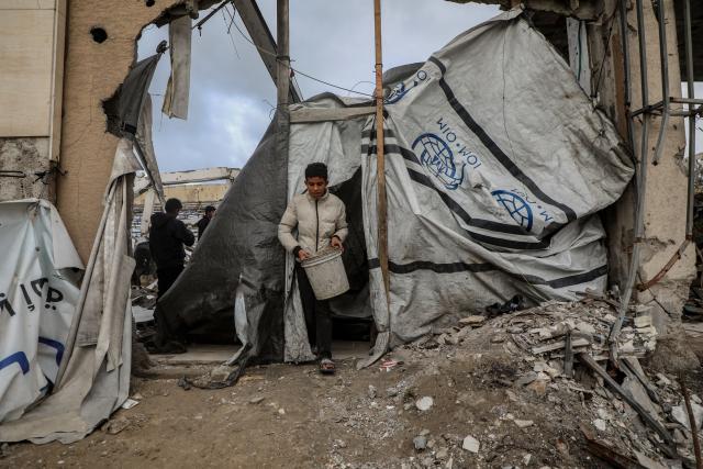 (260113) -- GAZA, Jan. 13, 2026 (Xinhua) -- Palestinians inspect a collapsed building due to the storm in Gaza City, Jan. 13, 2026. Four Palestinians were killed in Gaza City in two separate incidents, as heavy rain and strong winds swept the region on Tuesday. (Photo by Rizek Abdeljawad/Xinhua)