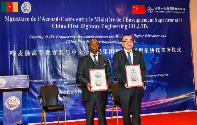 (260113) -- YAOUNDE, Jan. 13, 2026 (Xinhua) -- Cameroonian Minister of Higher Education Jacques Fame Ndongo (L) and Zhao Zongzhi, chief engineer of China First Highway Engineering Co., Ltd. (CFHEC) display signed documents after the signing ceremony of a framework agreement for the MINESUP-CFHEC Professional Certification Program in Yaounde, capital of Cameroon, Jan. 13, 2026. (Photo by Kepseu/Xinhua)