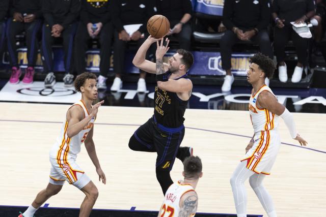 (260114) -- LOS ANGELES, Jan. 14, 2026 (Xinhua) -- Los Angeles Lakers' Luka Doncic (2nd L) shoots during the 2025-2026 NBA regular season game between Los Angeles Lakers and Atlanta Hawks in, Los Angeles, the United States, on Jan. 13, 2026. (Photo by Ringo Chiu/Xinhua)