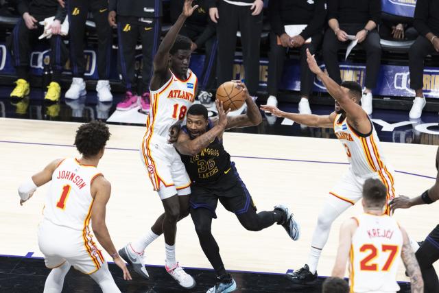 (260114) -- LOS ANGELES, Jan. 14, 2026 (Xinhua) -- Los Angeles Lakers' Marcus Smart (3rd L) drives the ball against Atlanta Hawks' Mouhamed Gueye (2nd L) during the 2025-2026 NBA regular season game between Los Angeles Lakers and Atlanta Hawks in, Los Angeles, the United States, on Jan. 13, 2026. (Photo by Ringo Chiu/Xinhua)