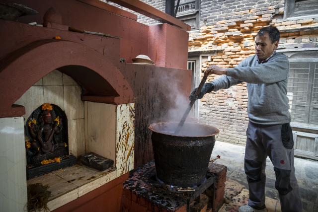 (260114) -- LALITPUR, Jan. 14, 2026 (Xinhua) -- A worker stirs molasses for the upcoming Maghe Sankranti Festival at a confectionery factory in Lalitpur, Nepal, Jan. 13, 2026. Nepalese prepare molasses ("Chaku" in local language) for the festival and the winter season. (Photo by Hari Maharjan/Xinhua)