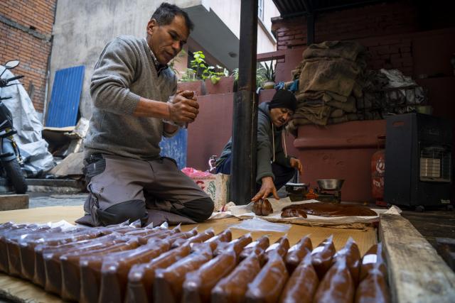 (260114) -- LALITPUR, Jan. 14, 2026 (Xinhua) -- Workers pack molasses for the upcoming Maghe Sankranti Festival at a confectionery factory in Lalitpur, Nepal, Jan. 13, 2026. Nepalese prepare molasses ("Chaku" in local language) for the festival and the winter season. (Photo by Hari Maharjan/Xinhua)
