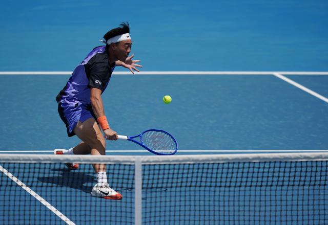 (260114) -- MELBOURNE, Jan. 14, 2026 (Xinhua) -- Coleman Wong of China's Hong Kong hits a return during the men's singles qualifying 2nd round match against Pablo Llamas Ruiz of Spain at Australian Open tennis tournament in Melbourne, Australia, Jan. 14, 2026. (Photo by Wang Shen/Xinhua)