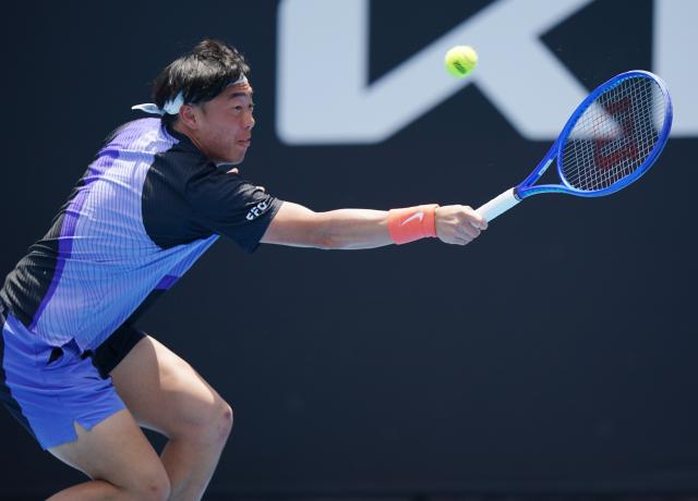 (260114) -- MELBOURNE, Jan. 14, 2026 (Xinhua) -- Coleman Wong of China's Hong Kong hits a return during the men's singles qualifying 2nd round match against Pablo Llamas Ruiz of Spain at Australian Open tennis tournament in Melbourne, Australia, Jan. 14, 2026. (Photo by Wang Shen/Xinhua)