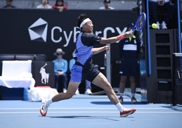 (260114) -- MELBOURNE, Jan. 14, 2026 (Xinhua) -- Coleman Wong of China's Hong Kong hits a return during the men's singles qualifying 2nd round match against Pablo Llamas Ruiz of Spain at Australian Open tennis tournament in Melbourne, Australia, Jan. 14, 2026. (Photo by Wang Shen/Xinhua)