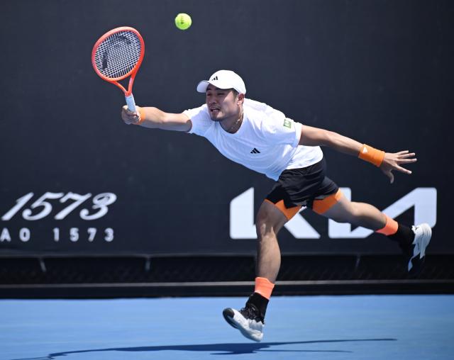 (260114) -- MELBOURNE, Jan. 14, 2026 (Xinhua) -- Wu Yibing of China hits a return during the men's singles qualifying 2nd round match against Nicolas Mejia of Columbia at Australian Open tennis tournament in Melbourne, Australia, Jan. 14, 2026. (Photo by Wang Shen/Xinhua)