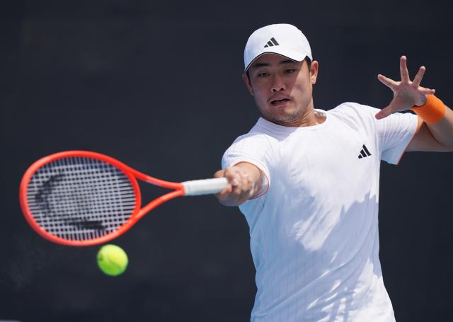 (260114) -- MELBOURNE, Jan. 14, 2026 (Xinhua) -- Wu Yibing of China hits a return during the men's singles qualifying 2nd round match against Nicolas Mejia of Columbia at Australian Open tennis tournament in Melbourne, Australia, Jan. 14, 2026. (Photo by Wang Shen/Xinhua)