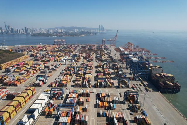(260114) -- BEIJING, Jan. 14, 2026 (Xinhua) -- An aerial drone photo taken on Jan. 14, 2026 shows cargo ships loading and unloading containers at a container terminal in Xiamen, southeast China's Fujian Province. Last year, China's foreign trade value hit 45.47 trillion yuan (about 6.48 trillion U.S. dollars), up 3.8 percent year on year, according to data released by the General Administration of Customs on Wednesday. This marks the ninth consecutive year of growth for China's foreign trade since 2017. (Photo by Zeng Demeng/Xinhua)