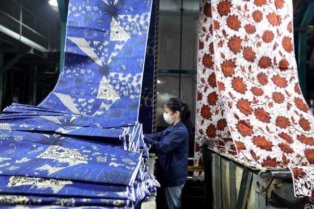 (260114) -- BEIJING, Jan. 14, 2026 (Xinhua) -- A worker processes fabric for export to Africa at a workshop in Binzhou, east China's Shandong Province, Jan. 14, 2026. Last year, China's foreign trade value hit 45.47 trillion yuan (about 6.48 trillion U.S. dollars), up 3.8 percent year on year, according to data released by the General Administration of Customs on Wednesday. This marks the ninth consecutive year of growth for China's foreign trade since 2017. (Photo by Chu Baorui/Xinhua)