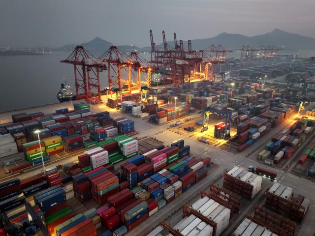 (260114) -- BEIJING, Jan. 14, 2026 (Xinhua) -- An aerial drone photo taken on Jan. 14, 2026 shows cargo ships loading and unloading containers at a container terminal at Lianyungang Port in Lianyungang, east China's Jiangsu Province. Last year, China's foreign trade value hit 45.47 trillion yuan (about 6.48 trillion U.S. dollars), up 3.8 percent year on year, according to data released by the General Administration of Customs on Wednesday. This marks the ninth consecutive year of growth for China's foreign trade since 2017. (Photo by Wang Chun/Xinhua)